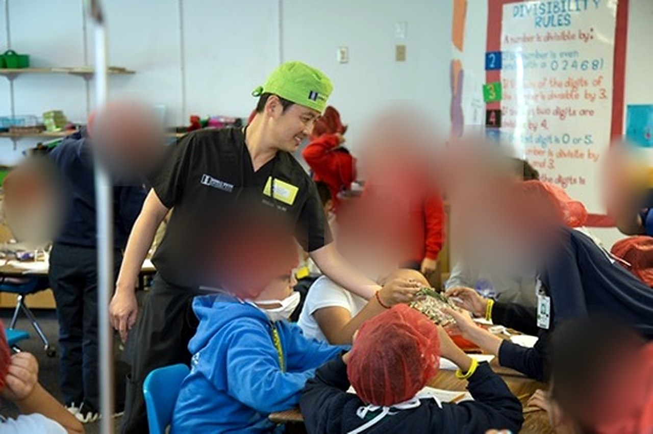 Sung Won, MD mentoring elementary students during a classroom activity
