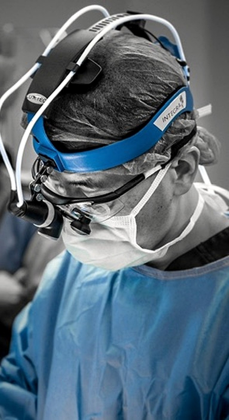 Sung Won, MD concentrating through surgical optics during his former surgical practice